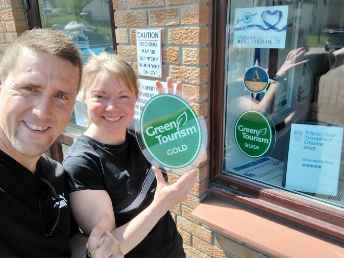 Man and a woman with a Green Tourism award