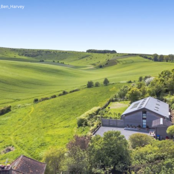 House in rolling downs green countryside.